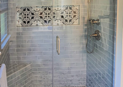 Primary bathroom addition with custom-tiled shower and custom-built vanity