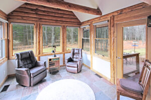 Traditional log cabin screen porch converted to 4 season sunroom.