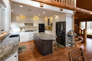 Traditional log cabin kitchen after remodel with rustic details.
