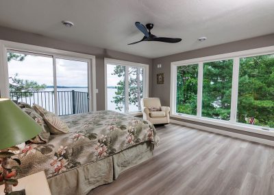 Bedroom with Floor to Ceiling Windows and Glass Doors to Deck