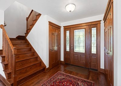 Stained Wood Door with Stained Glass and Sidelight Windows