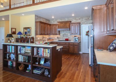 Medium Stained Wood Cabinetry with Earth-Toned Tile Backsplash