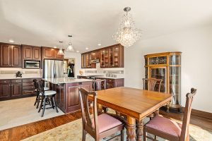 Medium Stained Wood Cabinetry with Ceramic Tile Flooring