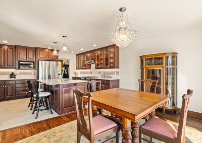 Medium Stained Wood Cabinetry with Ceramic Tile Flooring