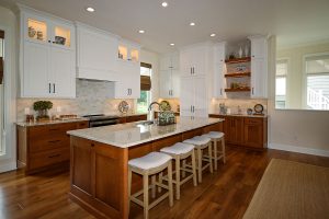 Stained Maple Island with Warm White Upper Cabinets, Ceramic Tile in Mixed Neutrals