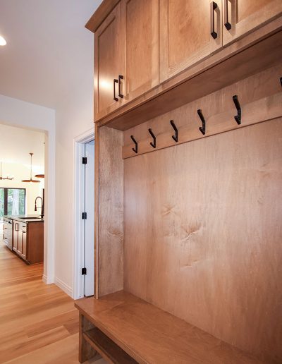 Mudroom with Bench with Hooks and Cabinets Above