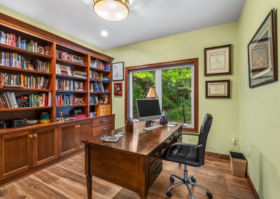 Office with custom-built cabinetry and shelving.