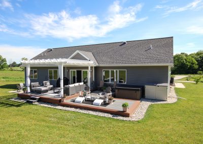 Back Exterior of custom-built home in northeast Wisconsin, with Pergola Covered Patio
