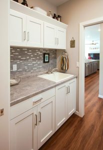 Mudroom with laundry room and drop-in sink, custom-built home in northeast Wisconsin